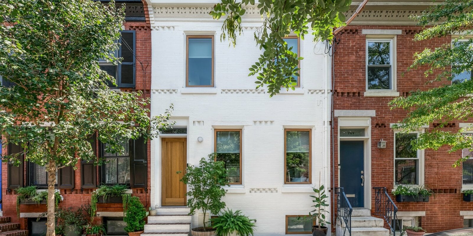 Philadelphia rowhomes on a tree-lined street